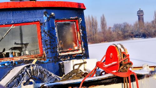 Close-up of red motorcycle on snow