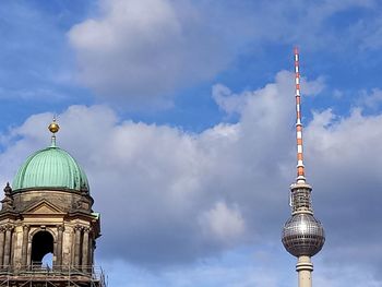Television tower in berlin and cupola of historical building next to it