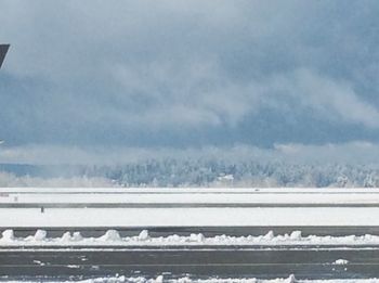 Snow covered landscape against sky