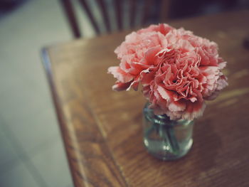 Close-up of rose in vase on table