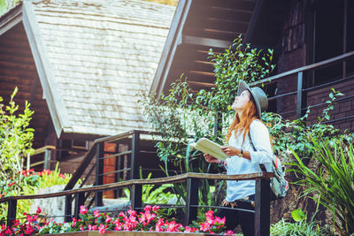 Woman sitting in front of building