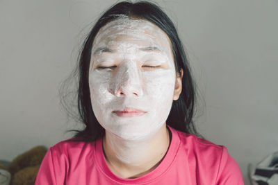 Close-up portrait of young woman with eyes closed