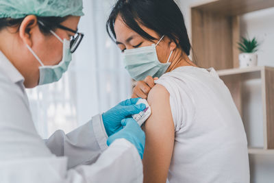 Doctor giving injection to patient in hospital