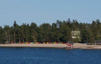 Scenic view of lake by building against clear sky