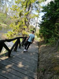 Man walking on footpath in forest