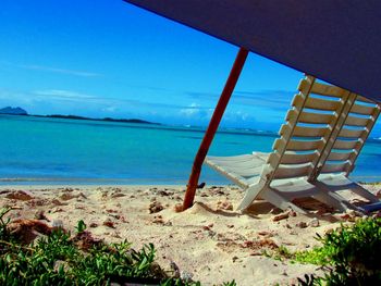 View of calm beach against blue sky