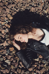 Directly above shot of young woman lying down on stones