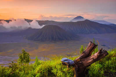 Scenic view of volcanic mountain against sky during sunset