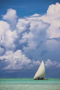 Sailboat in sea against sky