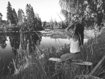 Woman standing at lakeshore