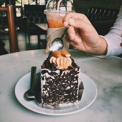 Midsection of man holding ice cream in plate