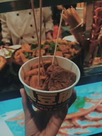 Close-up of hand holding ice cream