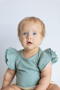 Portrait of cute baby boy against white background