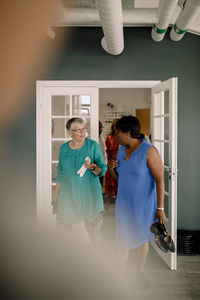 Multiracial senior women talking with each other while arriving in dance class