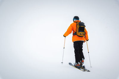 Ski tourist goes uphill. snow and winter sports, ski touring in the mountains, entertainment