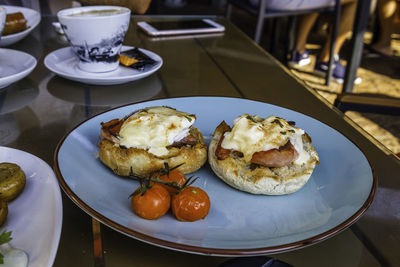 Breakfast with fried eggs, bacon, and grilled tomatoes