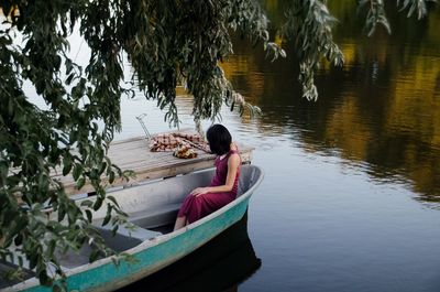 Woman sitting on boat in lake