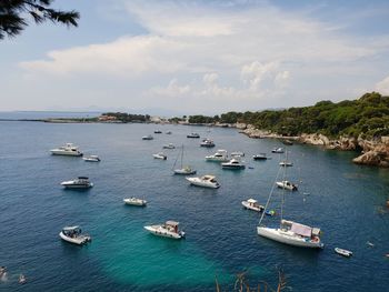 High angle view of sailboats moored on sea against sky