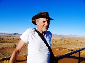 Man wearing hat against clear sky