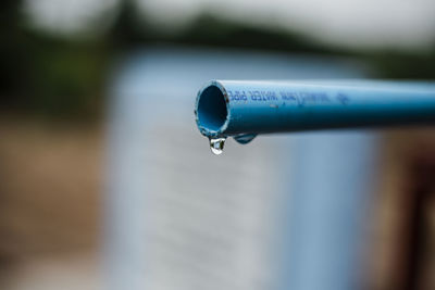 Close-up of water drop falling from pipe