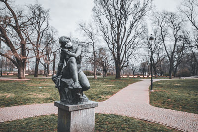 Statue in park against sky