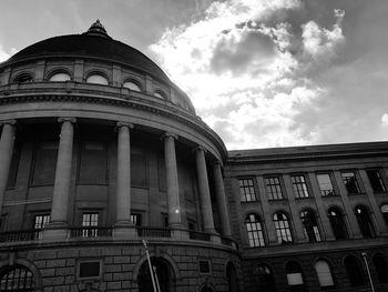 Low angle view of building against cloudy sky