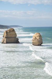 Rocks on sea shore against sky