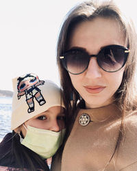 Close-up portrait of young woman wearing sunglasses