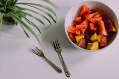 High angle view of chopped fruits in bowl on table