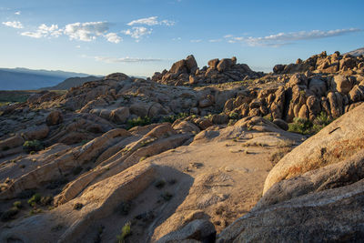 Rock formations on landscape against sky