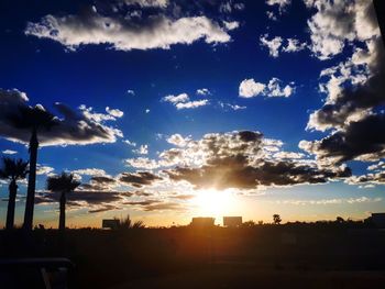 Silhouette city against sky during sunset