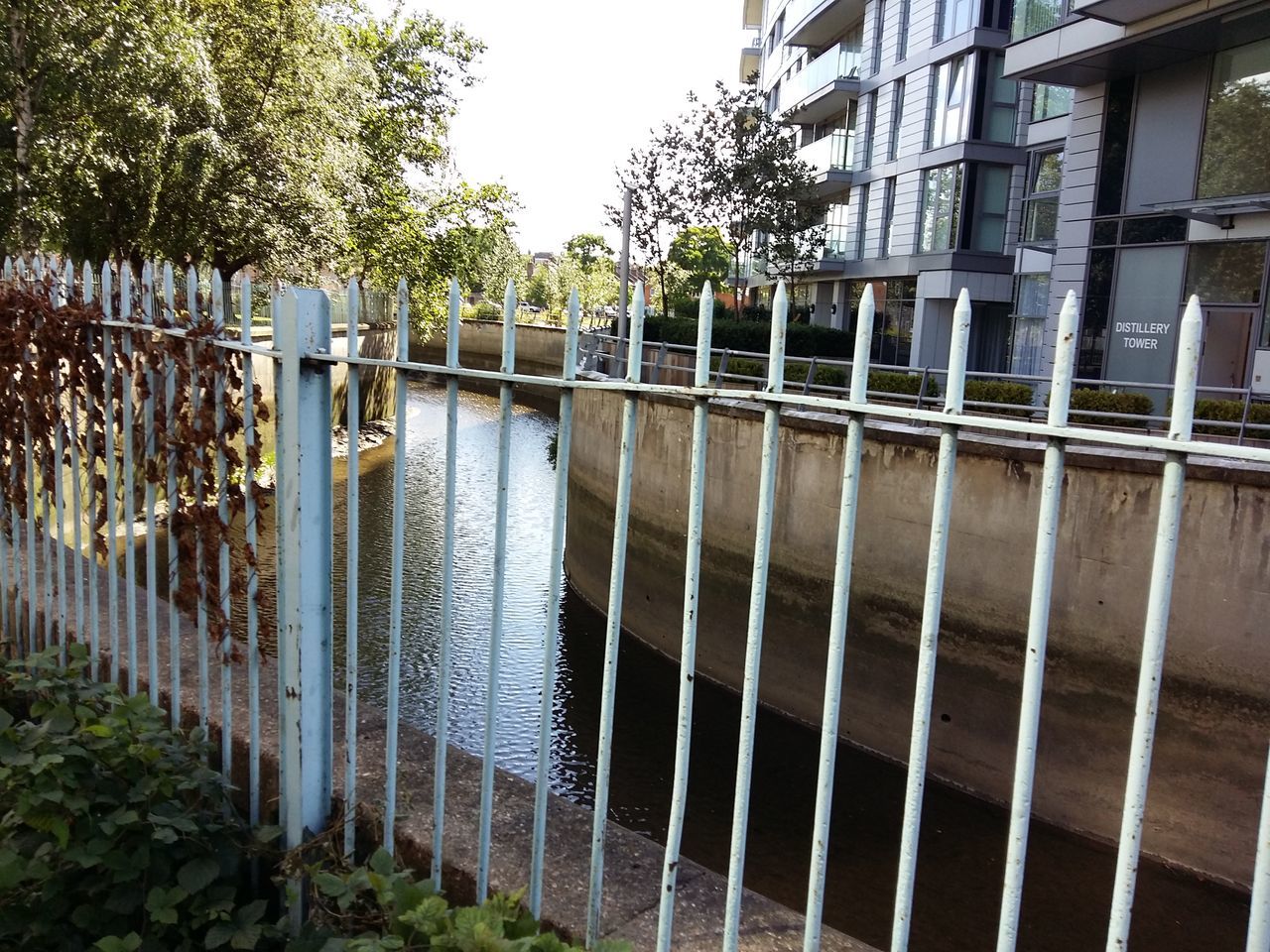 VIEW OF CANAL WITH BUILDINGS IN BACKGROUND