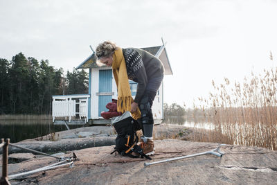 Injured woman packing her bag at the beach ready to go camping