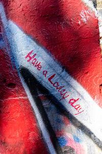 Close-up of text on red wall