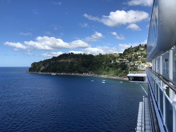 Scenic view of sea by buildings against sky