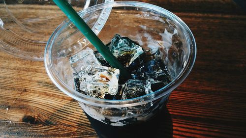 High angle view of ice cubes in drink on table