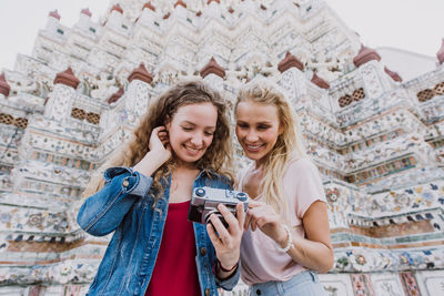 Happy women at temple in city