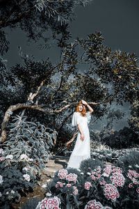 Woman standing with flowers on tree