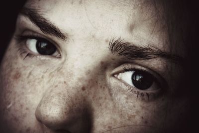 Close-up portrait of woman with freckle