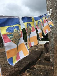 Clothes drying on clothesline against sky