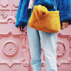 Midsection of woman standing against gate