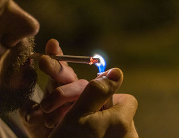 Close-up of man holding burning candles