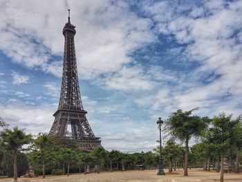 Low angle view of tour eiffel against cloudy sky