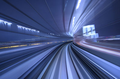 Light trails on railroad tracks in city