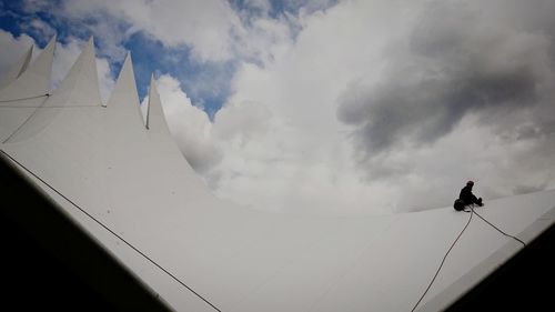 Low angle view of silhouette man against sky