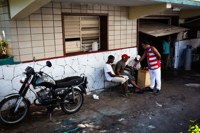Side view of a young man standing against building