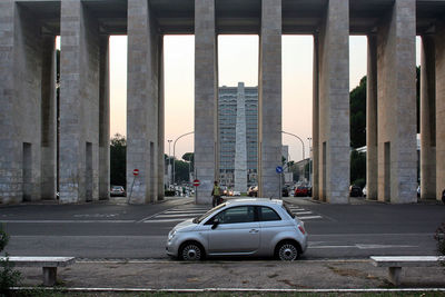 Cars on road by buildings in city