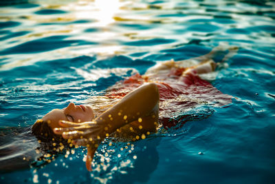 Young woman swimming in pool