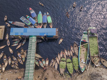 People unloading watermelons at old dhaka river port along buriganga river in dhaka, bangladesh.