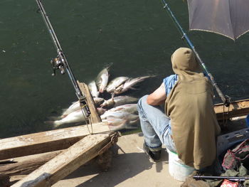 Rear view of man fishing in boat